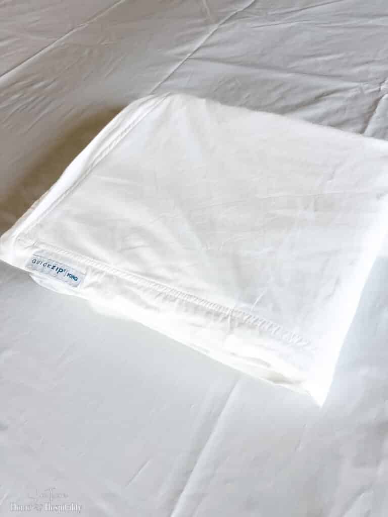 Folded top panel of zippered fitted sheet
