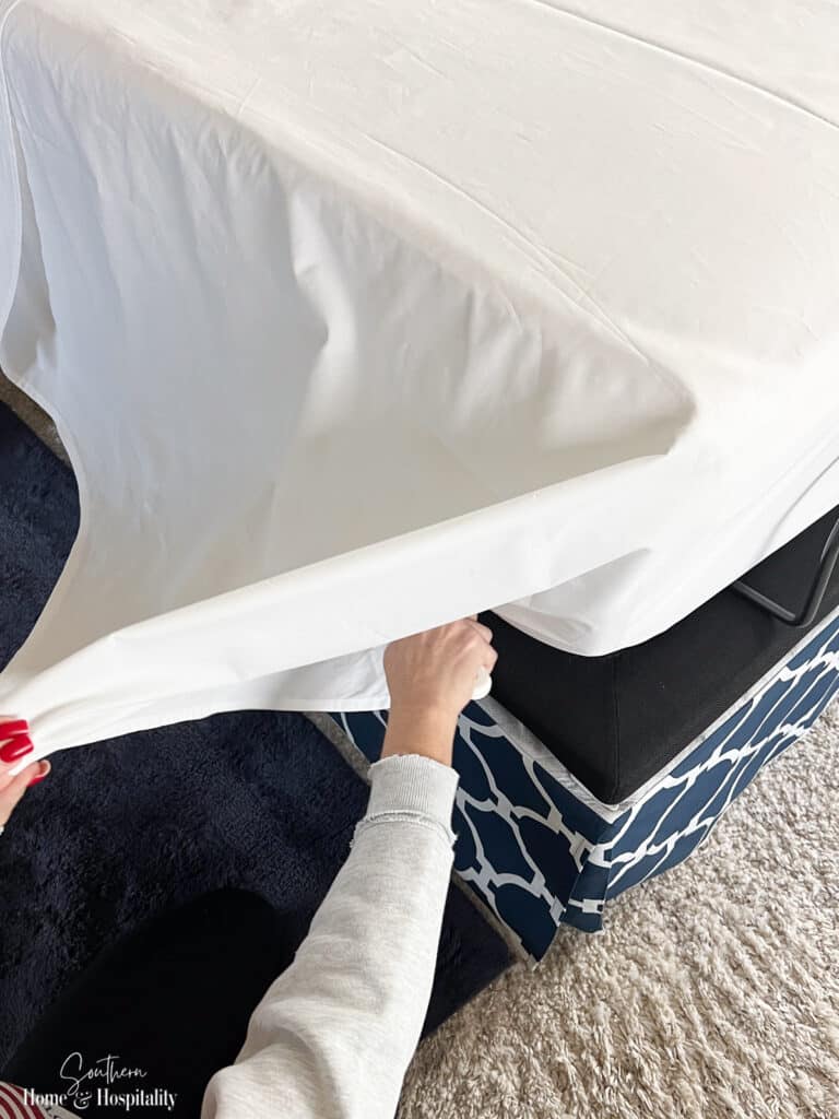 Tucking a neat corner of a flat sheet