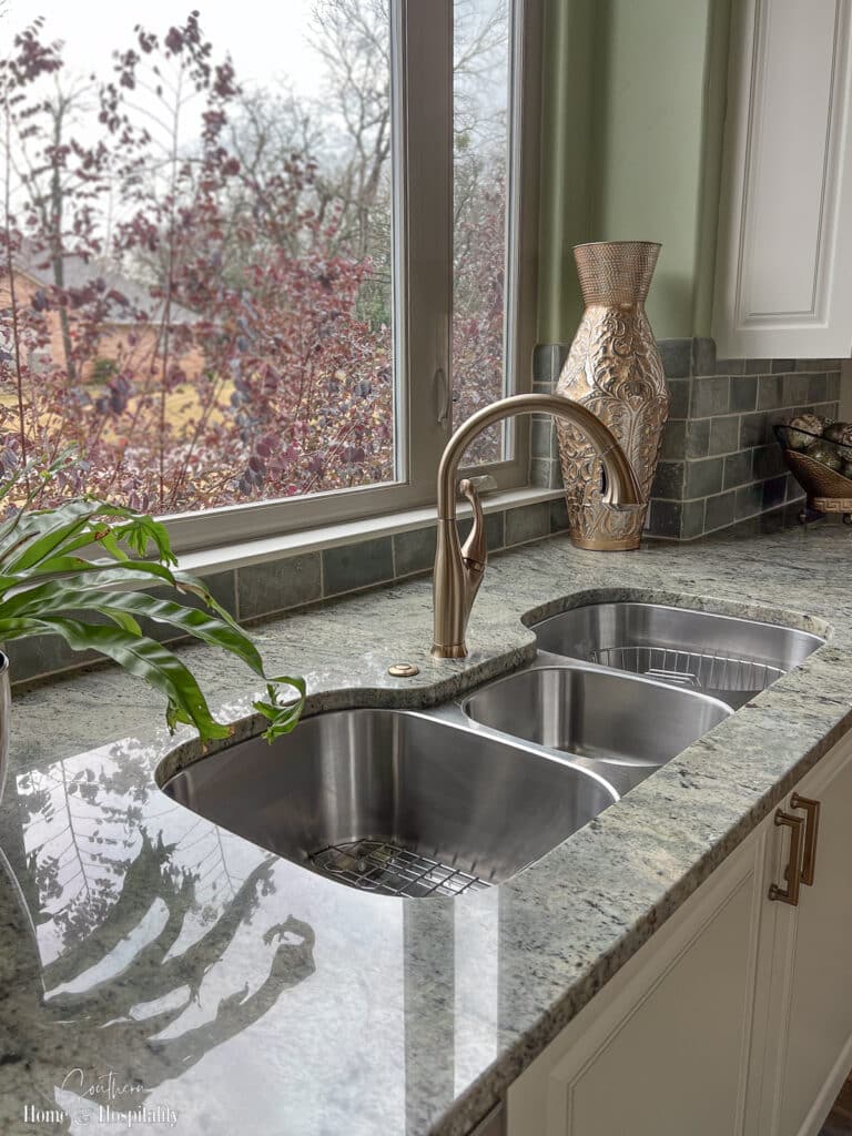 Three basin stainless steel sink in transitional kitchen
