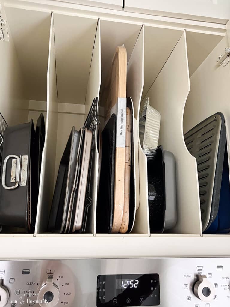 Vertical dividers in kitchen cabinet for baking sheets and trays