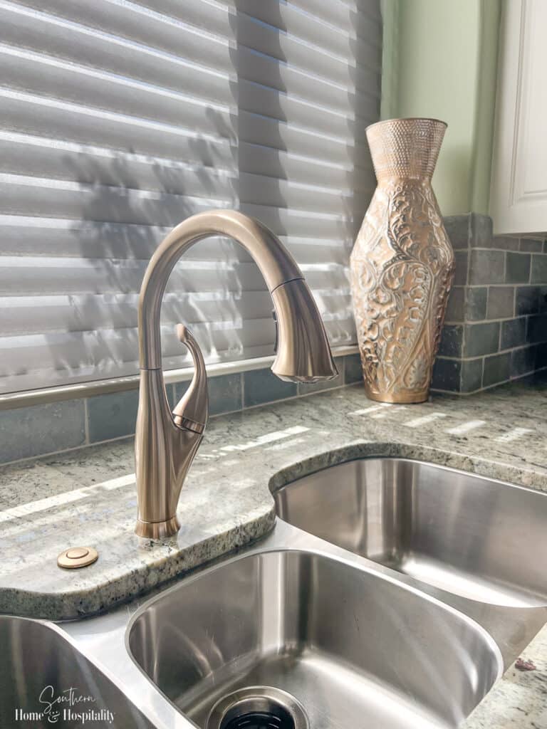 Champagne bronze Delta kitchen faucet in transitional style kitchen