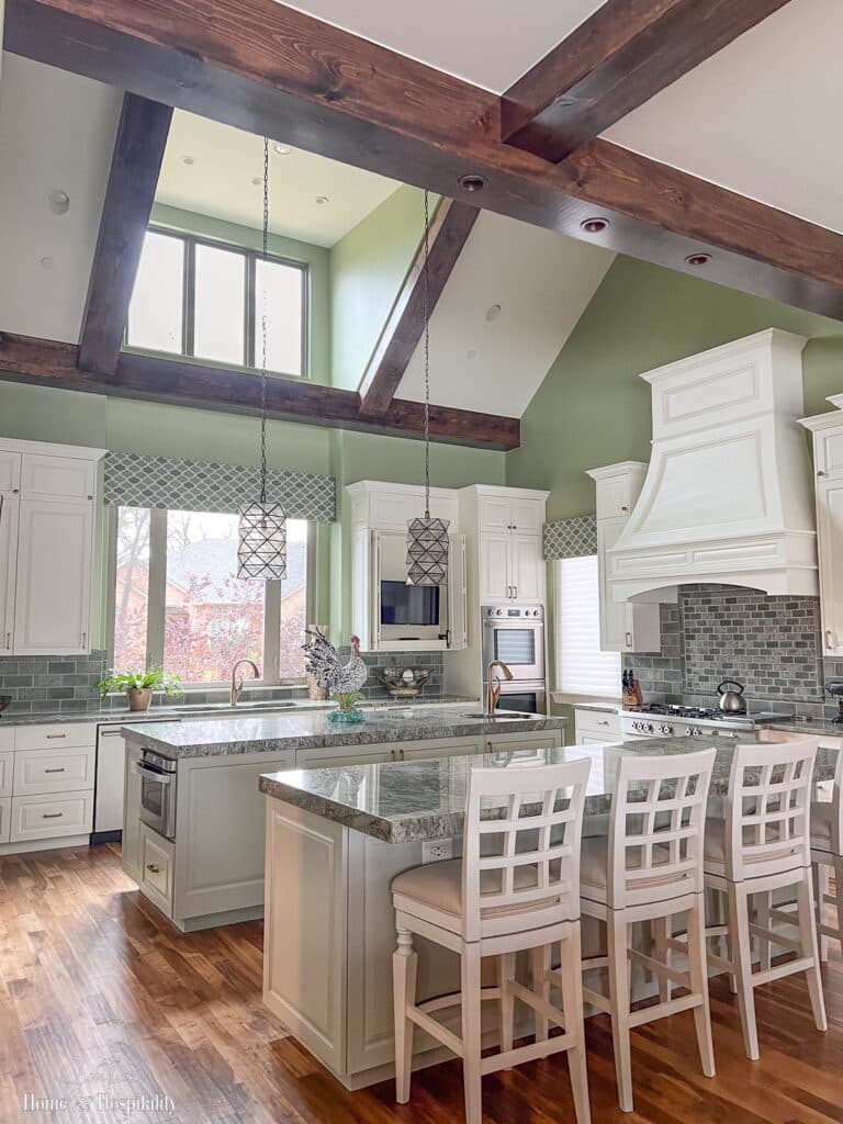 Transitional green kitchen with double islands