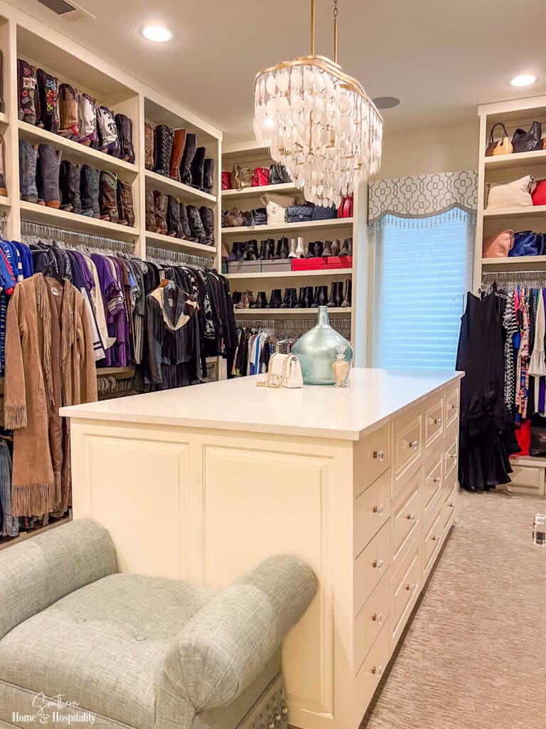 Custom master closet with island and chandelier