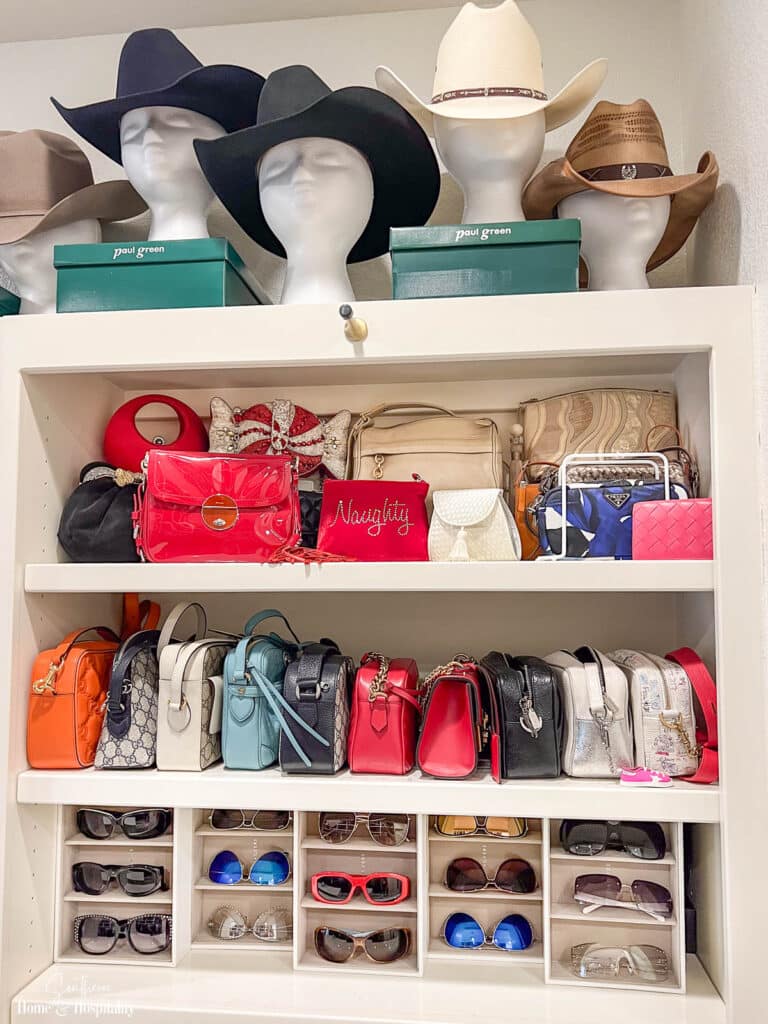 Purses, hats, and sunglasses displayed on closet shelves
