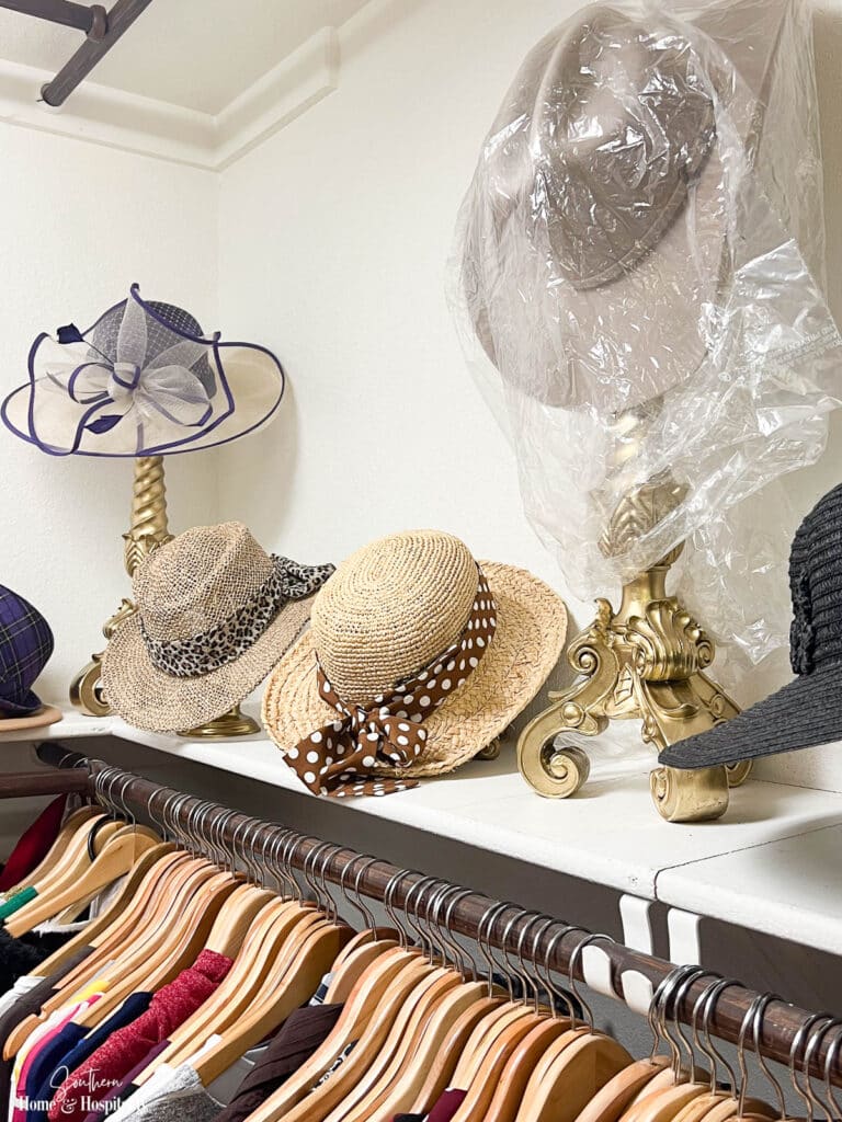 Hats displayed on candlesticks in closet