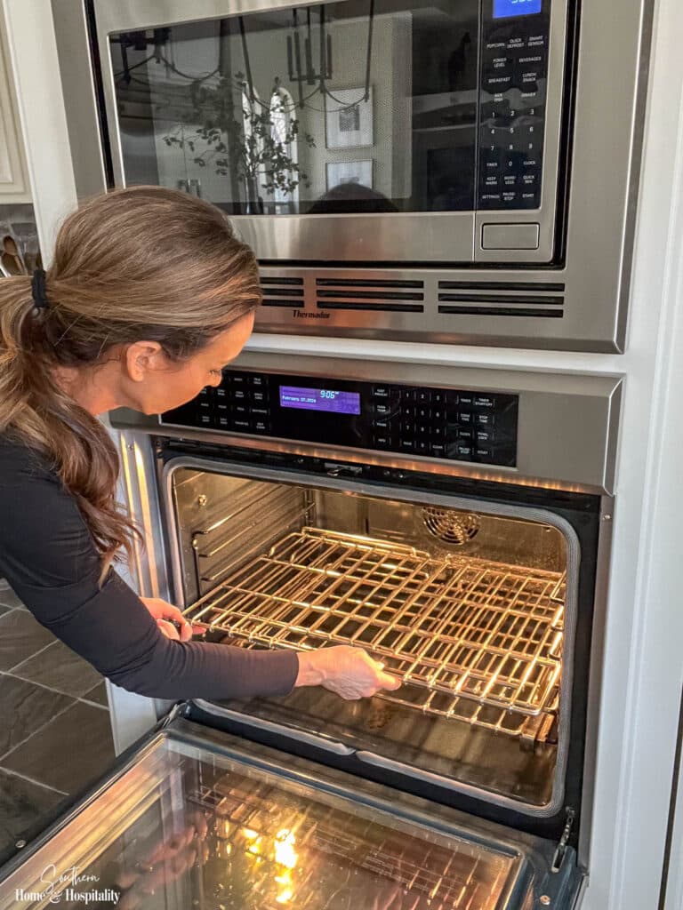 Removing racks from oven to get ready to clean