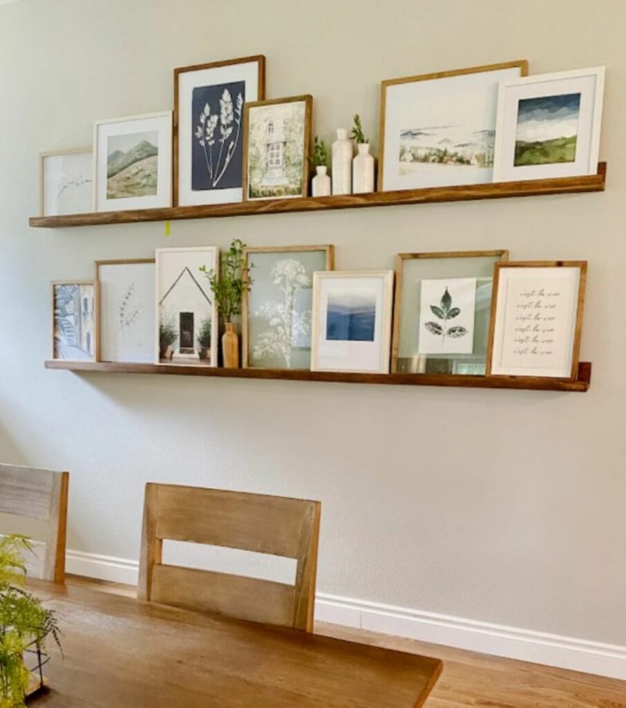 Picture rails filled with art on a dining room wall