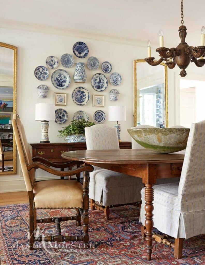 Blue and white dish collection hung on the wall in a dining room