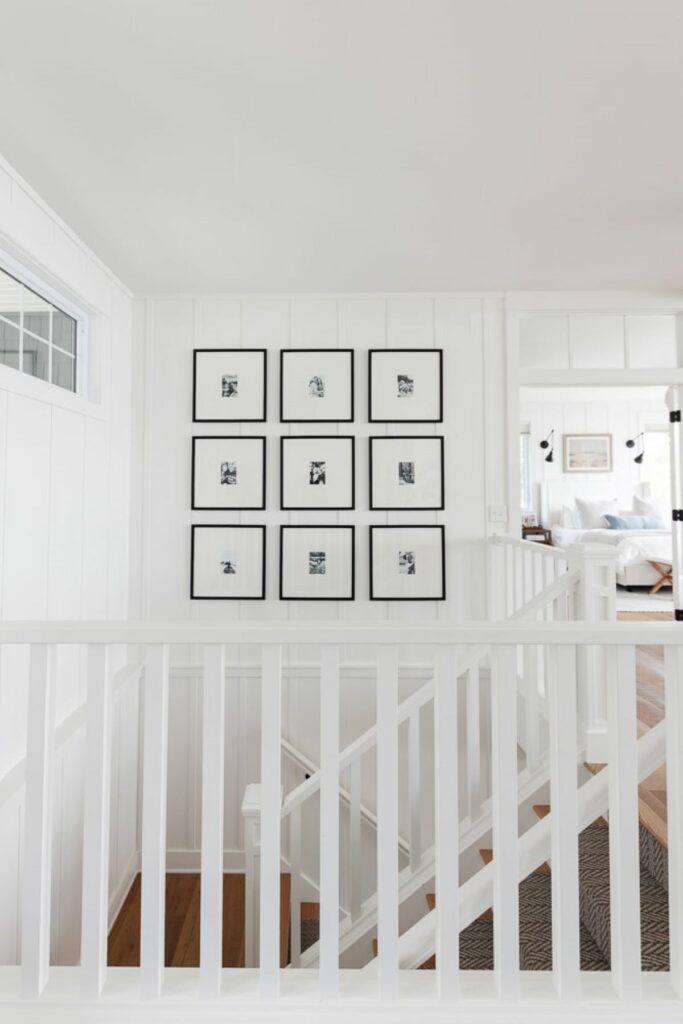 Black and white framed family photos in stairwell