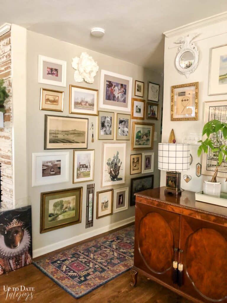 Mixed photo, art, and wall decor gallery covering a hallway wall