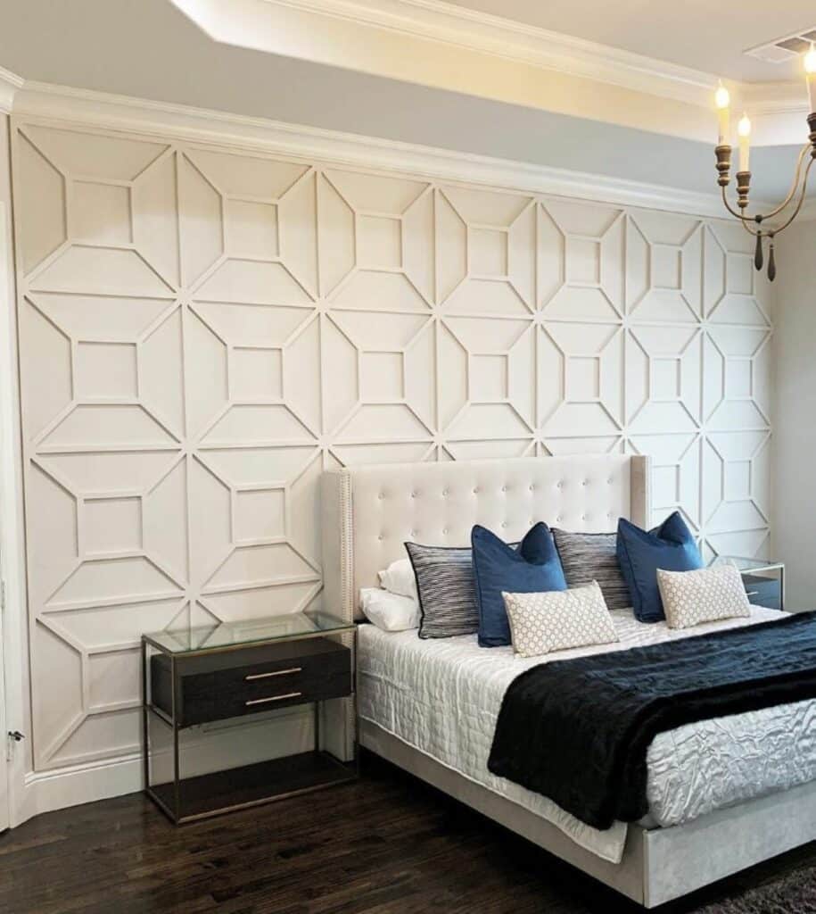 Fretwork molding accent wall behind a bed