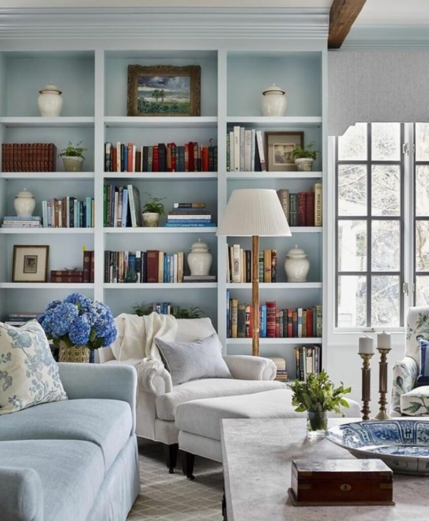 Wall of bookshelves with books and home decor objects