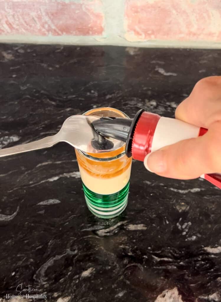 Layering Grand Marnier on Irish Flag shooter with a spoon