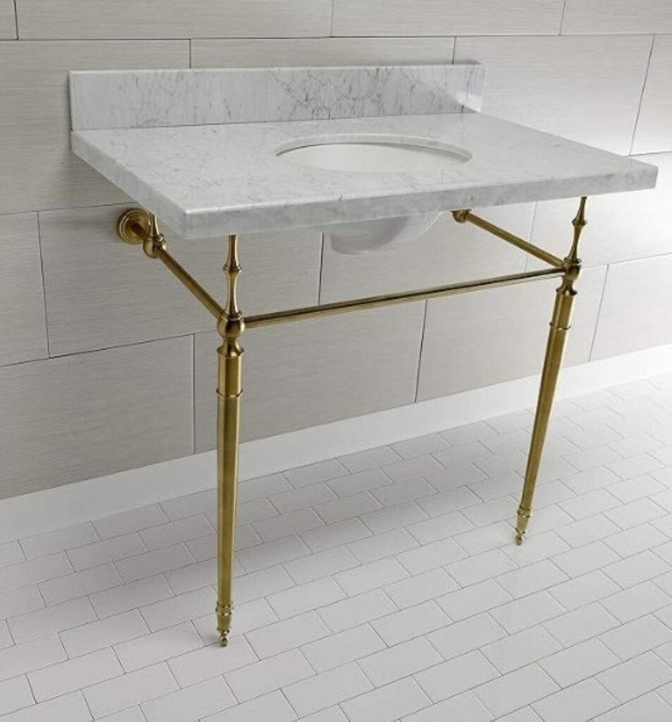 Console sink with brass legs and white marble counter