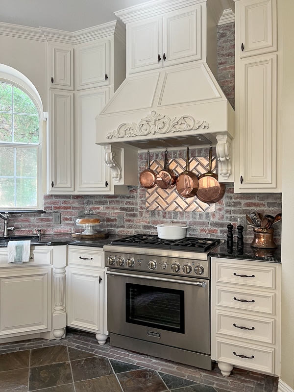 White cabinets with a stack of drawers with the correct size and placement for pulls