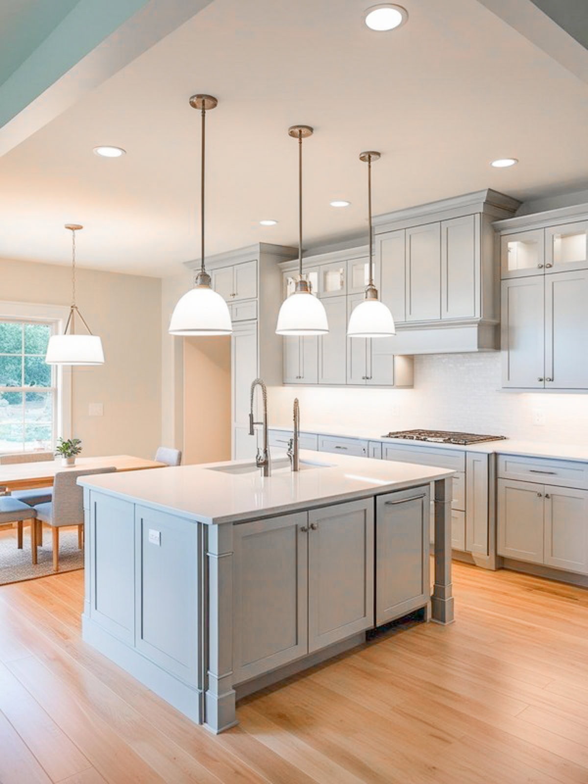 Builder grade brushed nickel lighting in kitchen