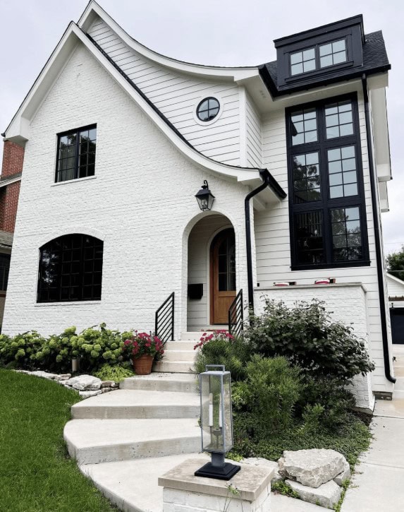 House with painted white brick and black windows