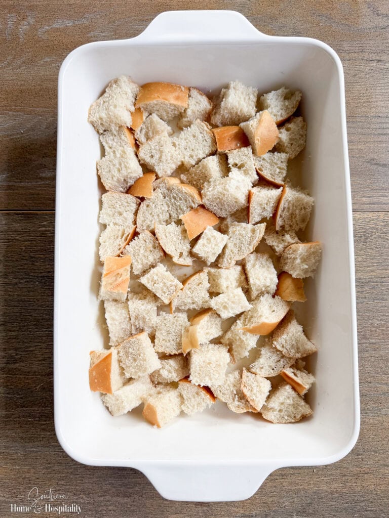 Bottom layer of cubed bread in casserole dish