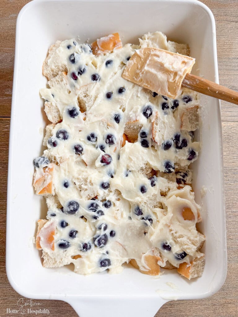 Spreading blueberry cream cheese filling over bread