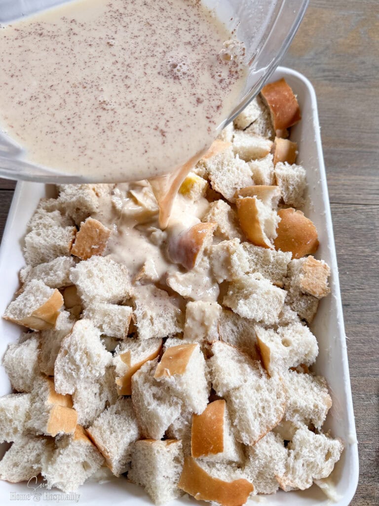 Pouring egg mixture over casserole