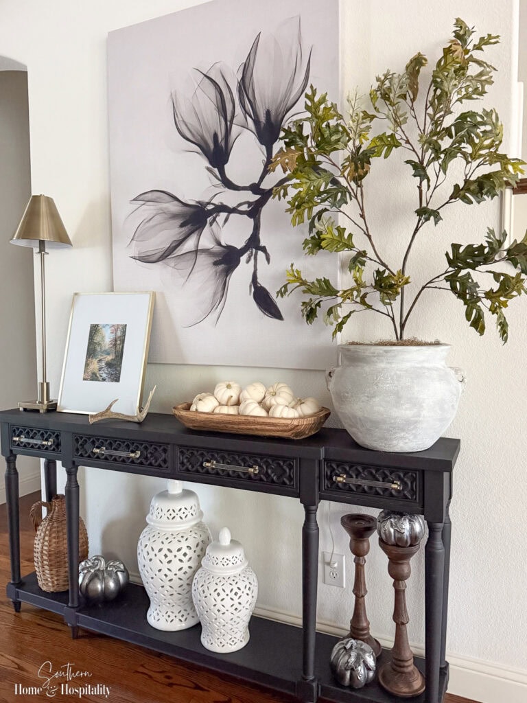 DIY aged metal pumpkins and natural textures for non-orange fall entryway decor.