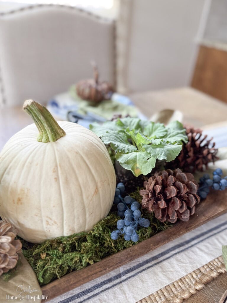 Fall dough bowl with white pumpkin and ornamental cabbage.