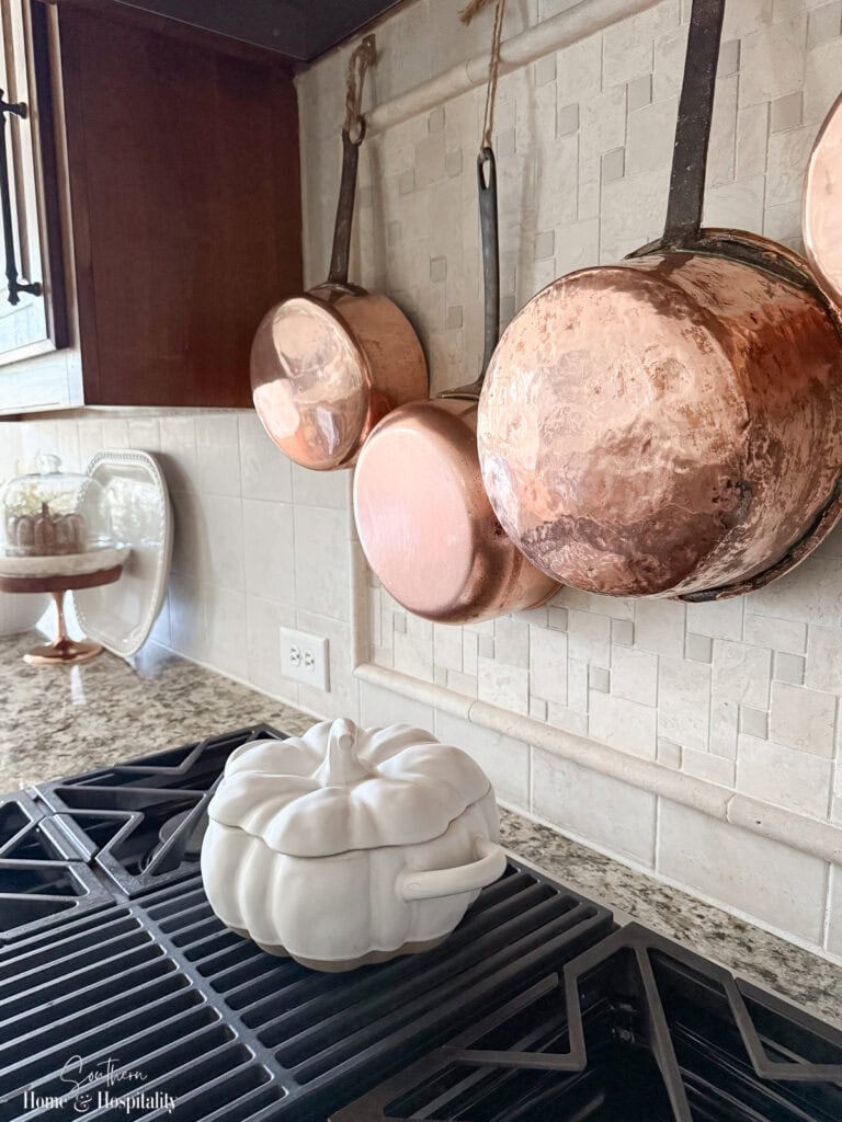 White pumpkin tureen displayed on kitchen cooktop for fall.