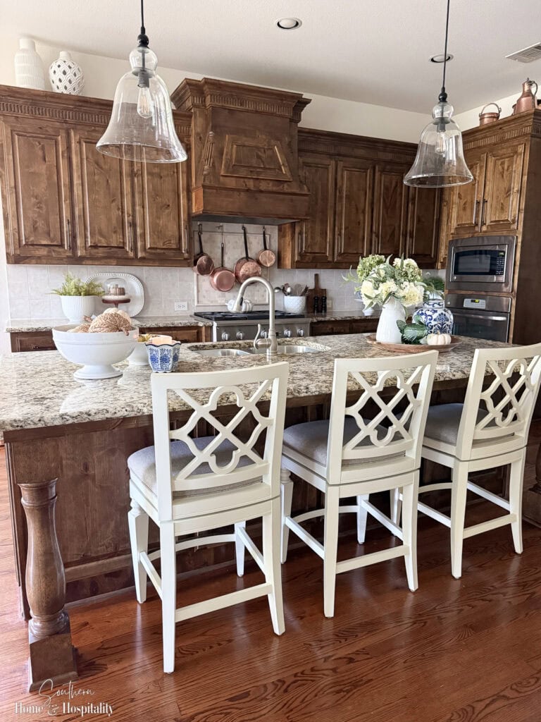 Fall kitchen island styled with blue and green accents.