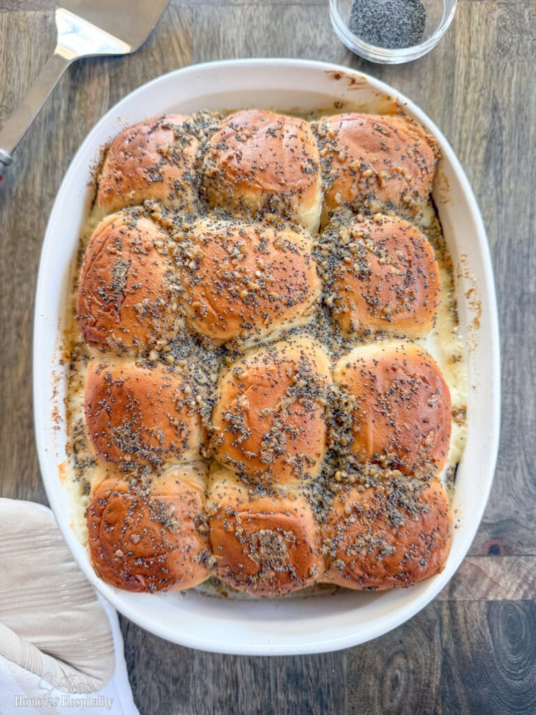 Golden brown baked ham and cheese sliders in 9x13 dish just out of the oven.