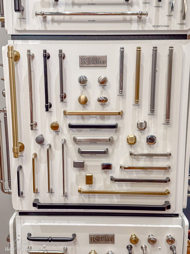 Display board of kitchen cabinet knobs and pulls in mixed finishes including brass, chrome, and matte black from Top Knobs.