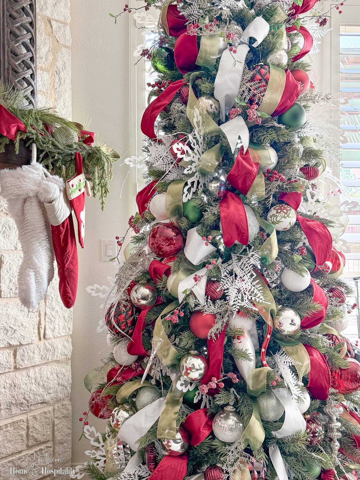 Decorated Christmas tree with ribbon loops and ornaments in red white and green