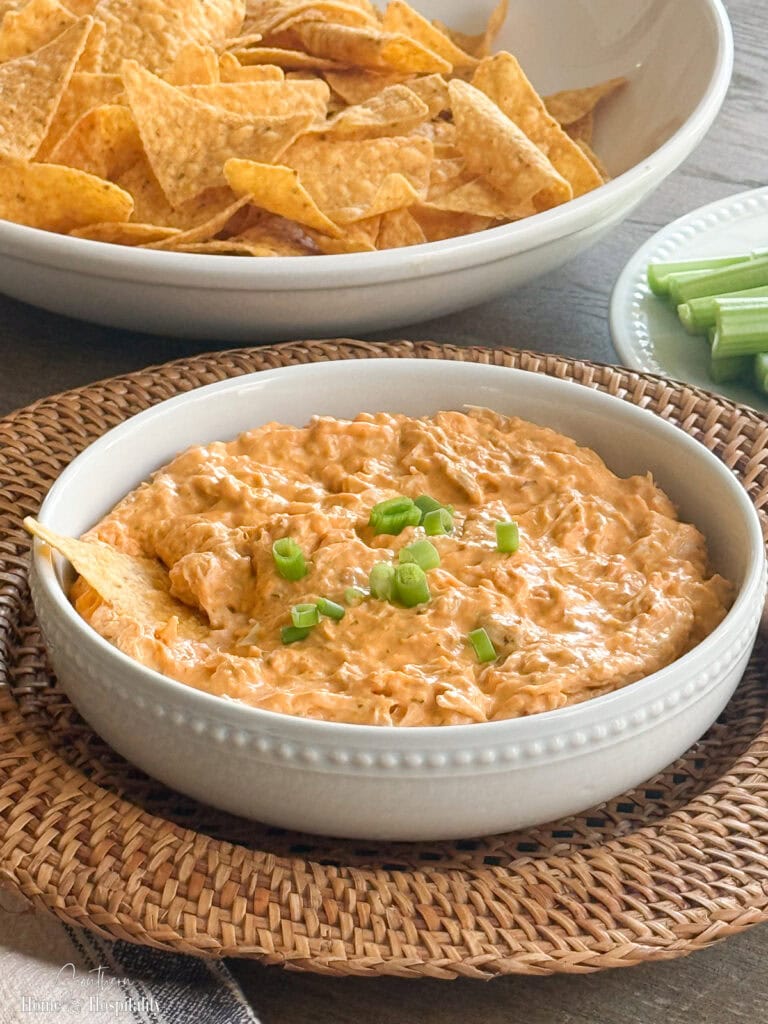 Buffalo chicken dip served with tortilla chips and celery sticks for dipping