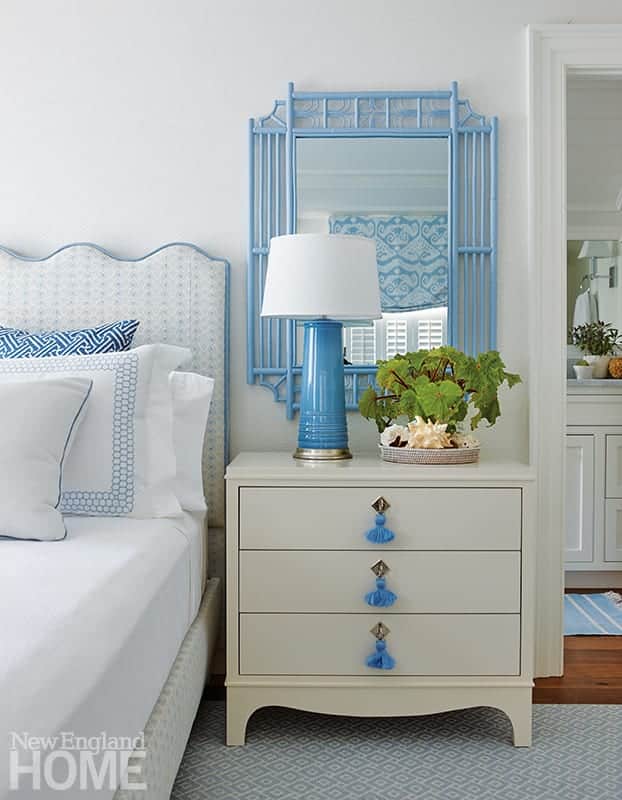 Blue and white bedside table with mirror over