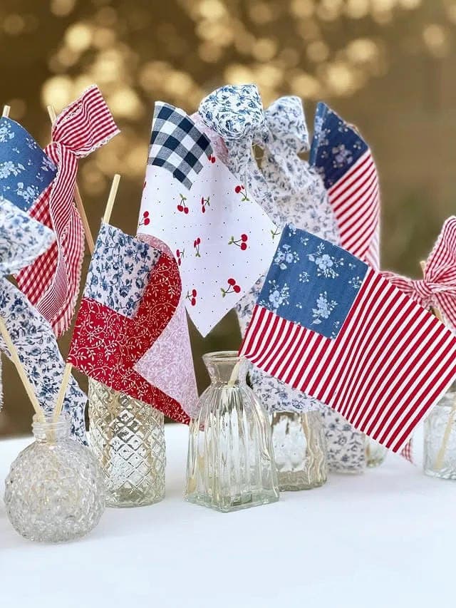 Red, white, and blue flags in clear vases