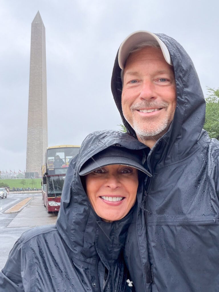 Couple in rain gear in front of the Washington Monument