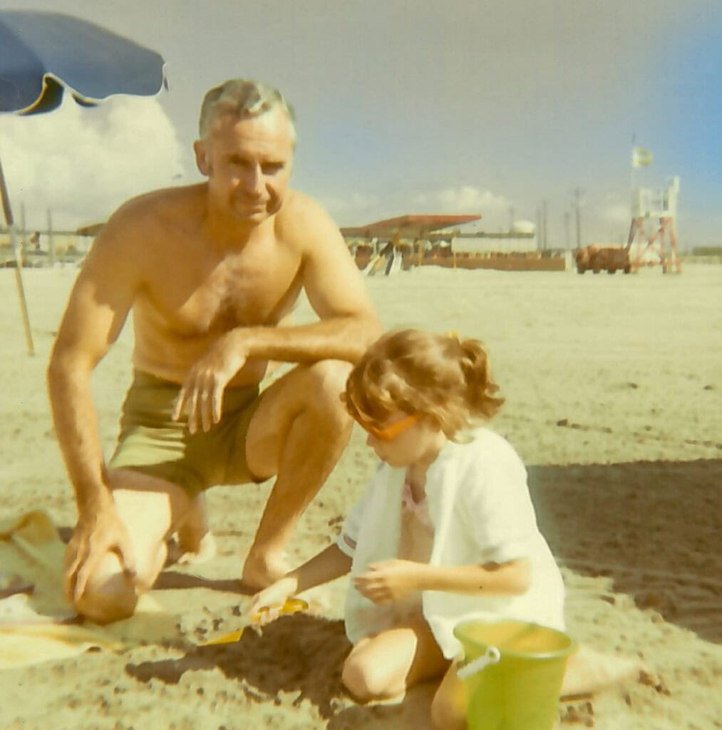 Father and little girl on beach