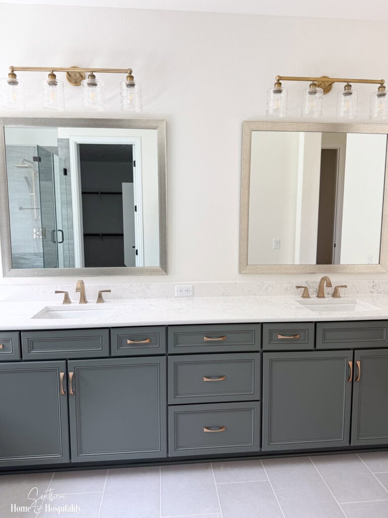 Bathroom vanity with champagne brass hardware, matching faucet, and coordinating light fixtures