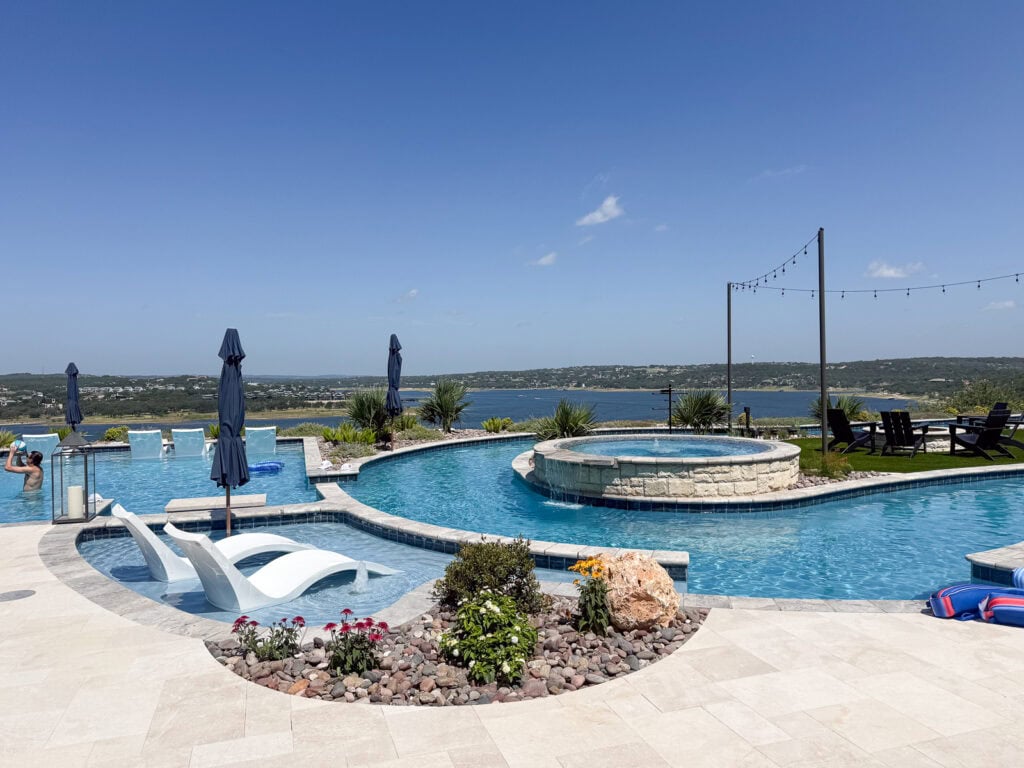 Infinity pool and lazy river overlooking Lake Travis on a sunny summer day in the Texas Hill Country.