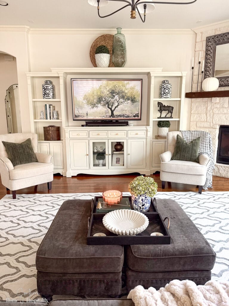 Bright living room featuring an updated entertainment center painted to match the trim.