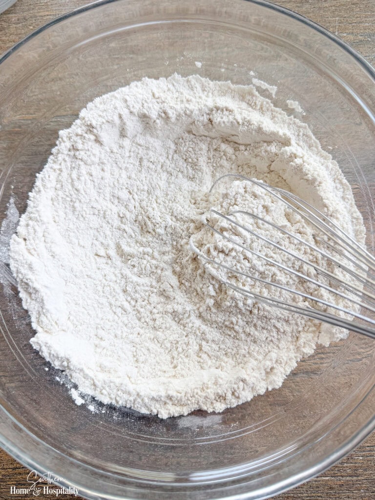Dry ingredients for Old-Fashioned Ranger Cookies whisked together in a mixing bowl.