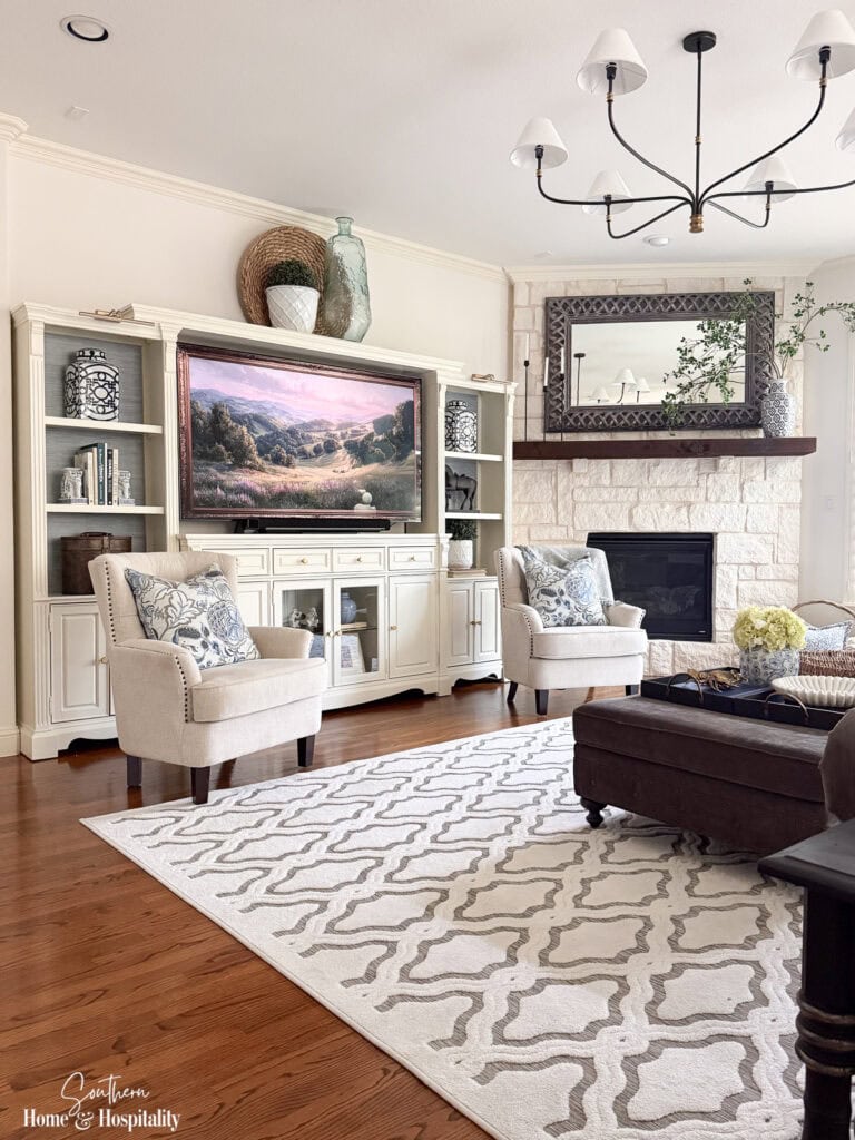 Bright living room featuring an updated entertainment center painted to match the trim.