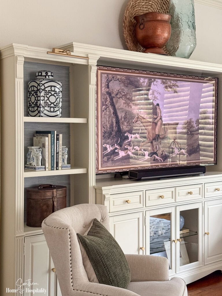Traditional entertainment center styled with blue and white porcelain, warm wood, leather, and brass accents
