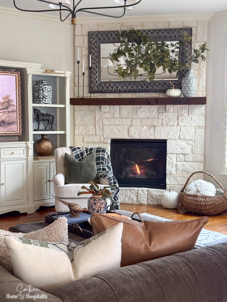 Ralph Lauren-inspired fall living room with blue and white decor, plaid, warm wood, and an Austin stone fireplace