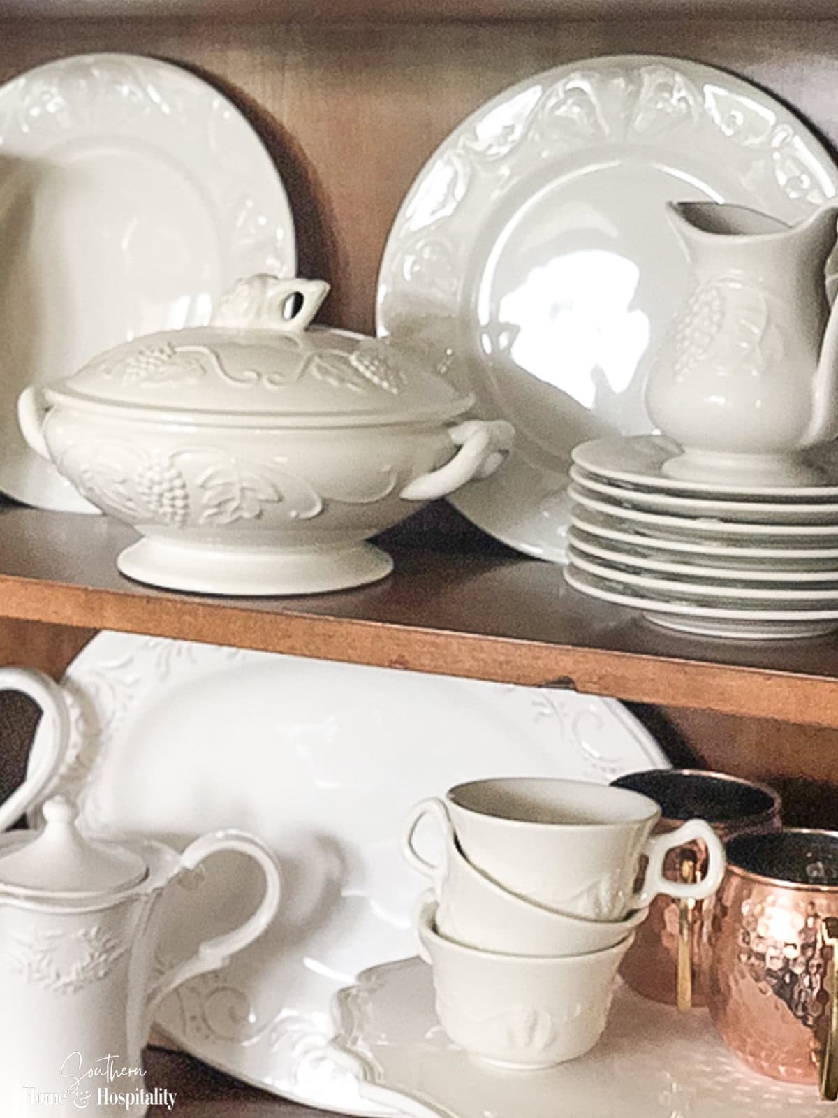 Vintage ironstone displayed in a hutch.