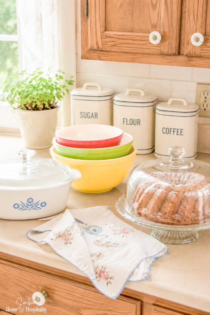 Vintage kitchen counter with labeled canisters, Blue Cornflower CorningWare, and other familiar 1970s kitchen staples.