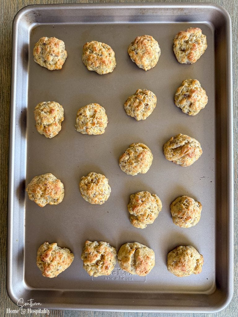 Freshly baked sausage balls with Bisquick and cheddar on a baking sheet