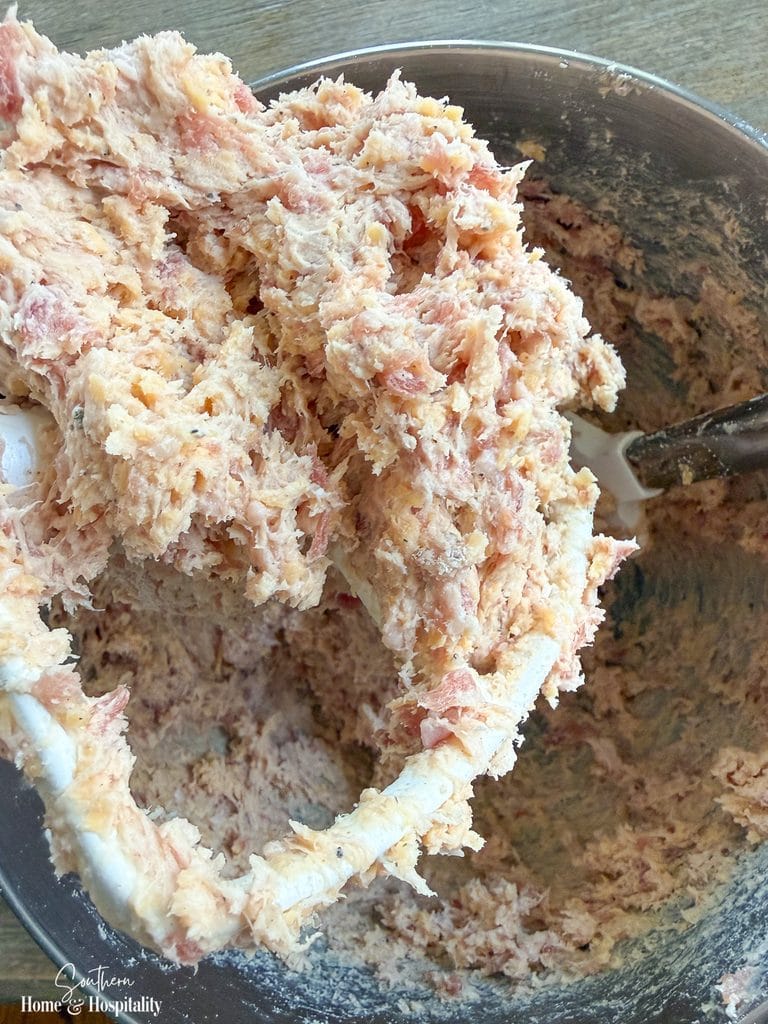 Sausage ball mixture with breakfast sausage, cream cheese, cheddar, and Bisquick