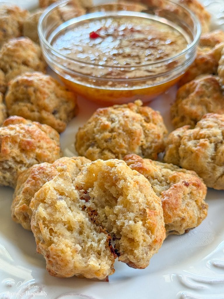Cream cheese sausage ball broken open to show the tender sausage and cheddar center