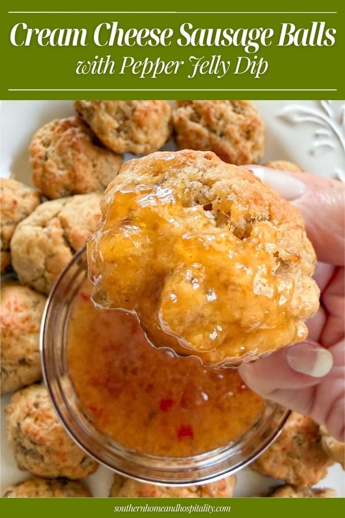 Cream cheese sausage balls with pepper jelly dip Pinterest pin showing a sausage ball being dipped into red pepper jelly-Dijon sauce