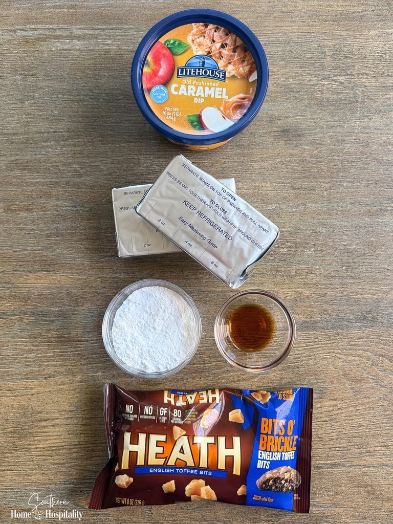 Ingredients for caramel apple dip with cream cheese, including caramel, cream cheese, powdered sugar, vanilla, and Heath toffee bits.